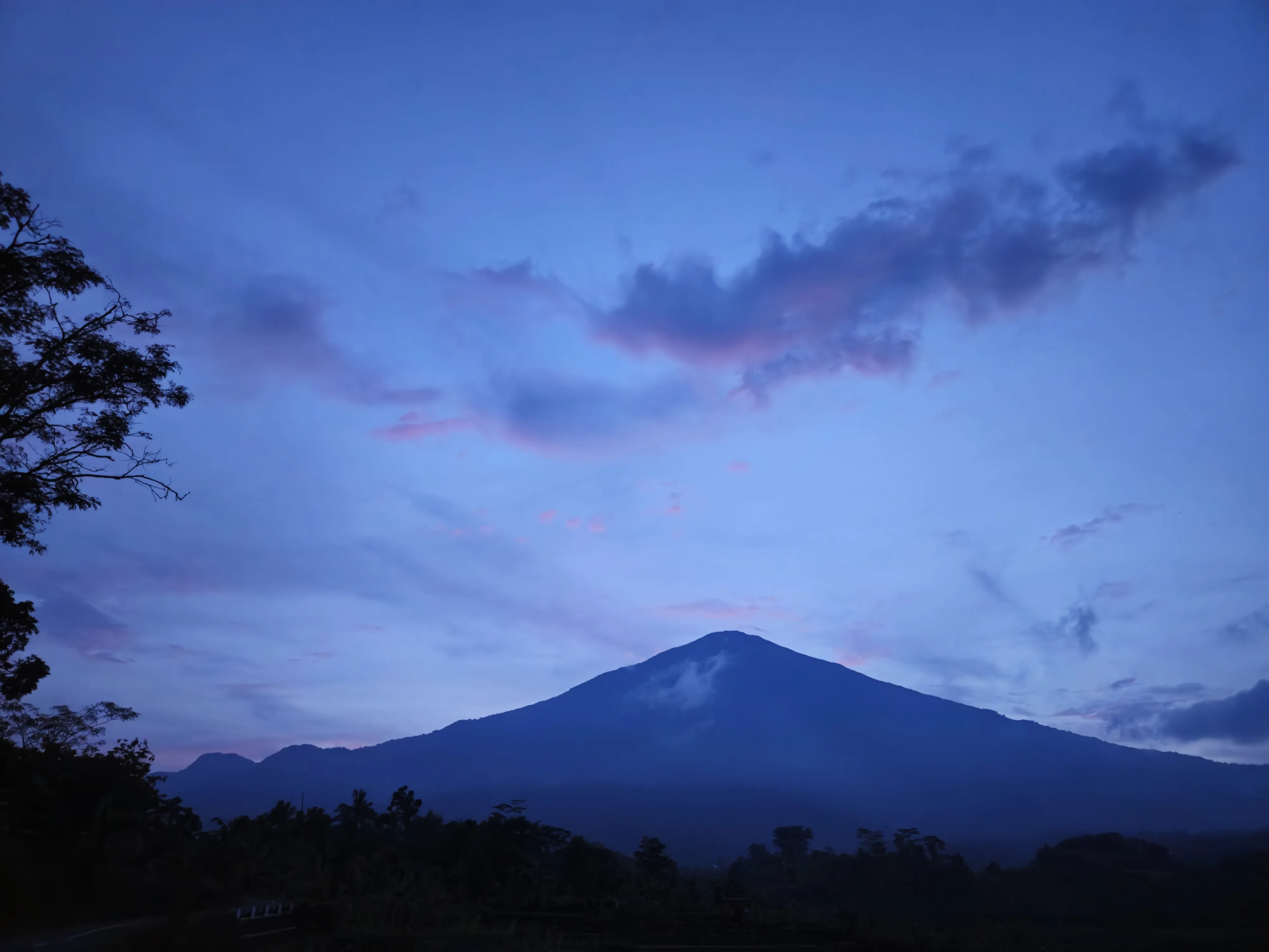 Mountain silhouette beneath a blue and purple sunset sky